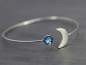 Mobile Preview: Silver MOON & EARTH bangle. Crescent moon with blue glass opal. Hand patinated silver. Adjustable