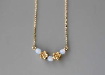 Dainty gold blue opal flower necklace. Tiny flowers and blue cz opal