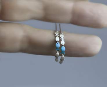 Swimming against the current. Dainty hoop earrings with blue fish