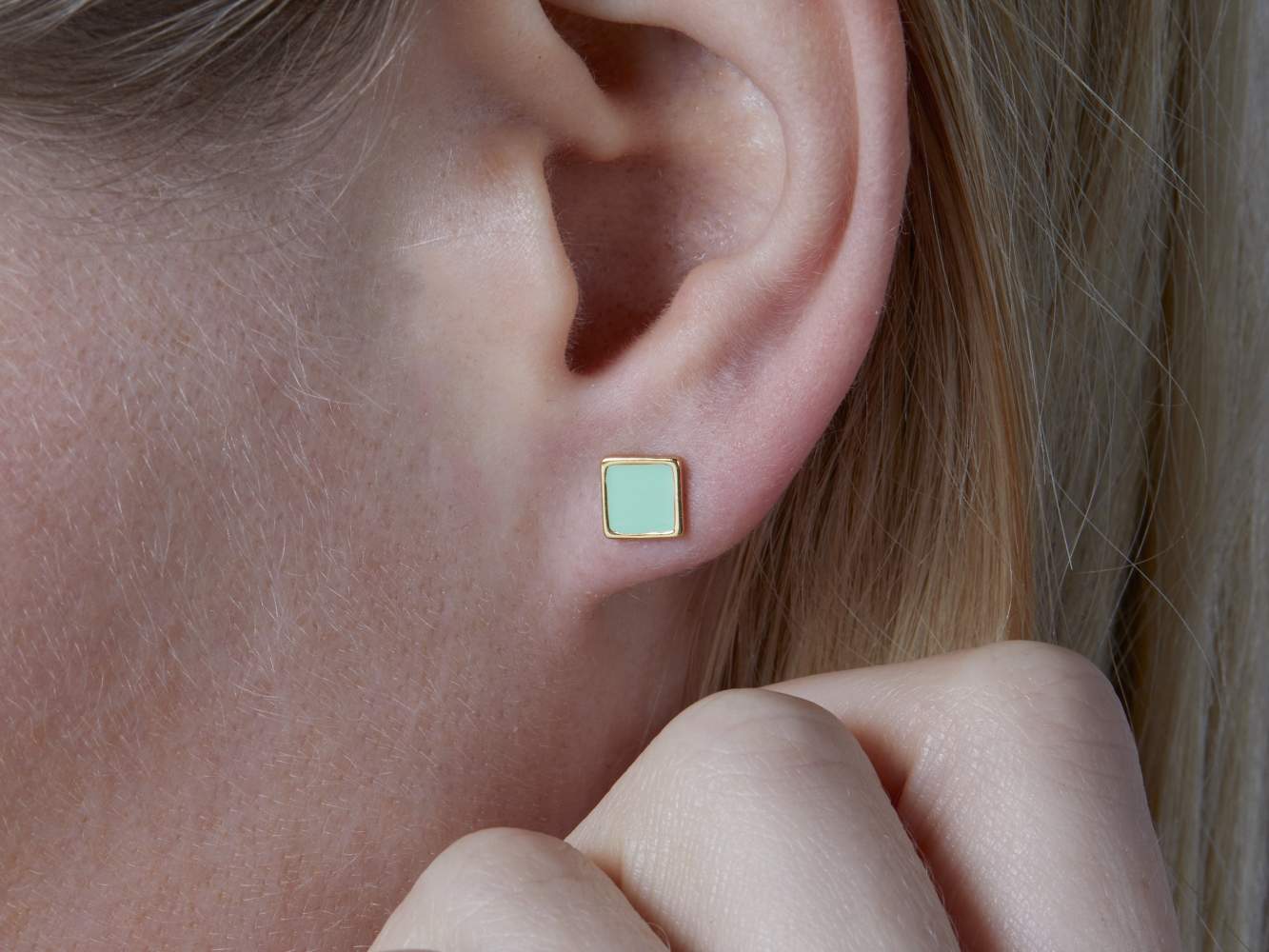 Mismatched stud earrings. 18k gold over sterling and enamel. Square stud ear worn.
