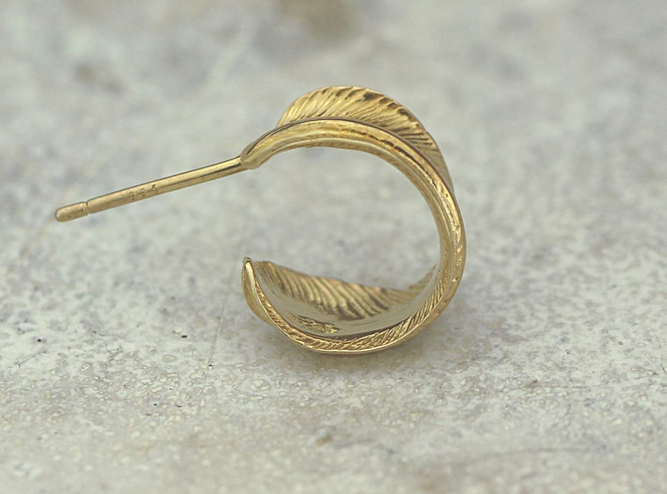 Gold feather open hoop stud earrings. Gold over sterling